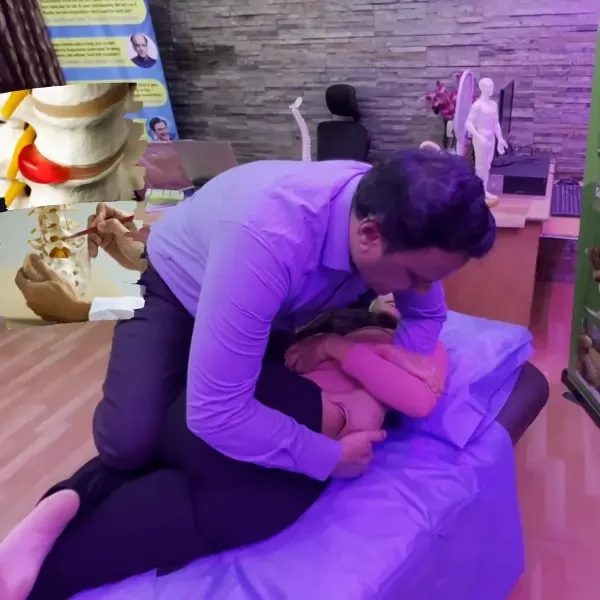 Dr. Rudresh, Europe-Certified Chiropractor, demonstrating a non-surgical chiropractic adjustment for lower back pain treatment at AcuSTAR Wellness in Bangalore.
